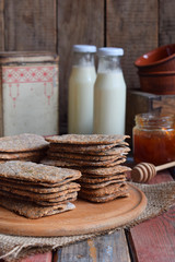 Healthy food concept. Breakfast with crispbreads, milk, jam. Flatbread crackers with sesame, flax seed, pumpkin and sunflower seeds. Diet crispy cookies. Snack gluten-free. Copy space