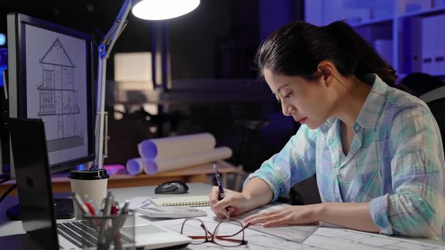 Architect using laptop and draw the blueprint.