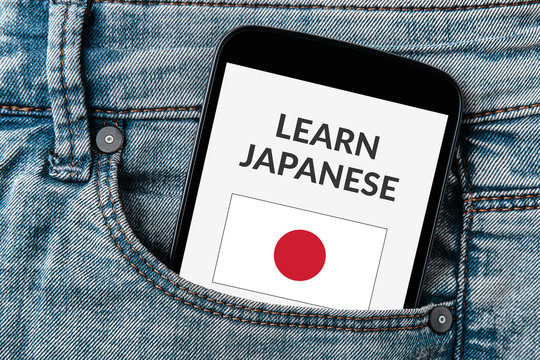 Learn Japanese concept on smartphone screen in jeans pocket. All screen content is designed by me. Flat lay