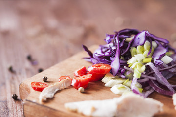 Vegetable salad of red cabbage, hot pepper, red and green onions with baked meat. Spring salad with meat. Horizontal. Close up. Place for text.  Deadpan