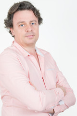 Studio shot of young handsome man arms crossed