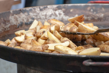 Potatoes fried in a large frying pan