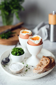 Breakfast with boiled eggs and toasted bread. Vertical, selective focus