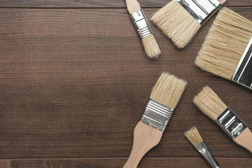 paint brushes on the brown wooden table