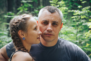 Adult man and a young girl in the forest