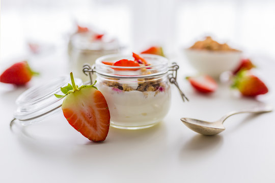 Delicious yogurt with e fresh strawberries and granola. 