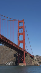 Vertical section of the suspension and view of the northern tower of the iconic Golden Gate Bridge, San Francisco, California, USA