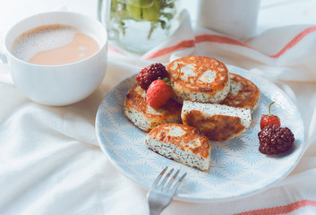 syrniki with poppy seeds on a wooden surface. concept of a healthy breakfast