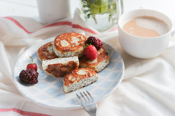 syrniki with poppy seeds on a wooden surface. concept of a healthy breakfast