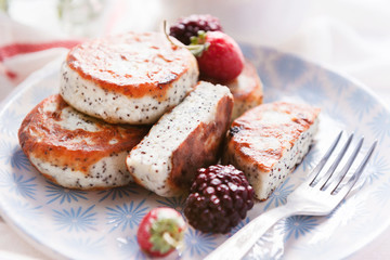 syrniki with poppy seeds on a wooden surface. concept of a healthy breakfast