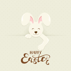 Fototapeta premium Easter bunny behind a banner