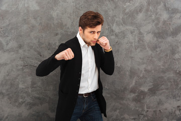Serious young businessman boxer