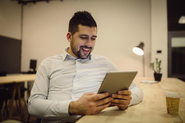 Young businessman using tablet computer.