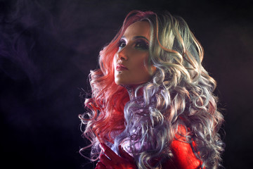 Beautiful woman with bright hair. Bright hair color, hairstyle with curls.