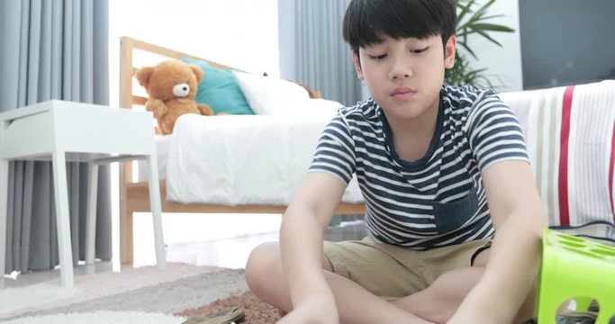 Asian cute boy doing your hose housework, housekeeping, and household concept.