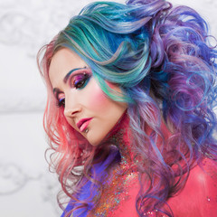 Fototapeta premium Beautiful woman with bright hair. Bright hair color, hairstyle with curls.