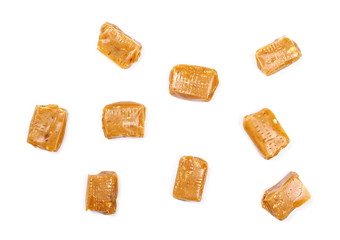 Caramels, pieces isolated on white background, top view