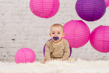A little boy with a pacifier in his mouth