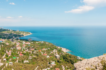 Fototapeta na wymiar Beach at the seaside, blue water, view from above the mountains to the town of Simeiz, Yalta, Crimea