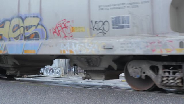 GRAFFITI ON A PASSING TRAIN IN THE CITY.