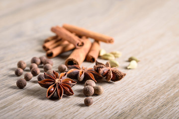 Various Spices background. Cinnamon sticks and anise stars close-up on wood background