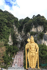 Batu Caves entrance and Lord Murugan Statue in Kuala Lumpur Malaysia. Batu Caves are located just north of Kuala Lumpur,and have three main caves featuring temples and Hindu shrines.