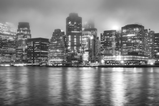 Black and white picture of the Manhattan on a foggy night, New York City, USA.