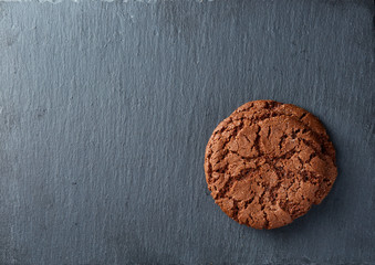 Lowkey picture of two chocolate cookies on dark background, close-up, shallow depth of field