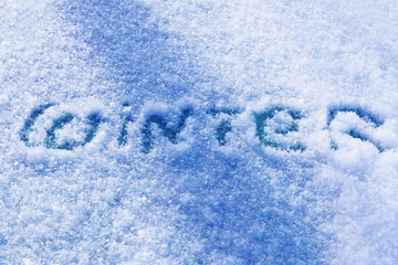 The inscription on the snow - WINTER. Conceptual abstract photo on the theme of winter and snow. 