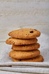 Stack of Chocolate chip cookies on wooden background. Stacked chocolate chip cookies shot with selective focus.