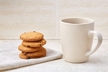 Close-up white cup of coffee with chocolate chip cookies on white background, top view