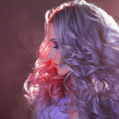 Fototapeta premium Beautiful woman with bright hair. Bright hair color, hairstyle with curls.