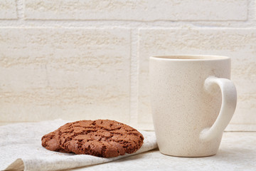 Close-up white cup of coffee with chocolate chip cookies on white background, top view