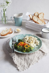 Breakfast buffet with eggs, toast, and a bowl with cheese, selective focus.
