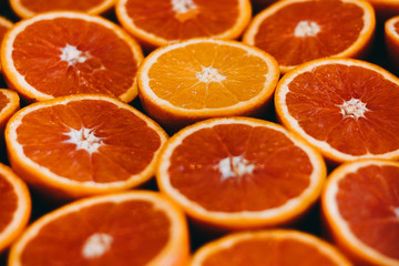 Abstract red background with citrus-fruit of grapefruit slices. Close-up
