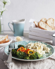 Scramble eggs for Breakfast with toast and broccoli. Vertical. closeup. selective focus. Deadpan