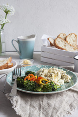 Scramble eggs for Breakfast with toast and broccoli. Vertical. closeup. selective focus.