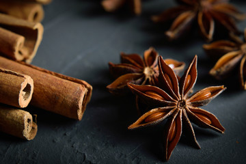  shelves of cinnamon and anise stars in dark colors on a dark concrete stone background