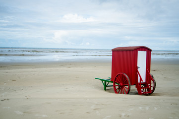 desrted seaside with a red bathing machine