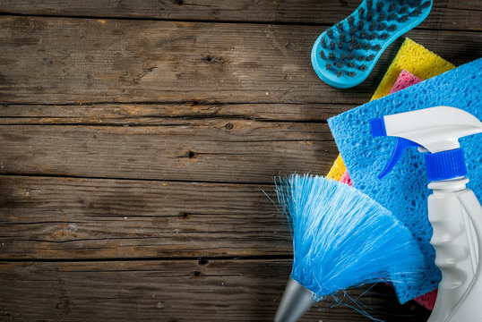 Spring Cleaning Concept With Supplies, House Cleaning Products Pile. Household Chore Concept, On Rustic Or Garden Wooden Background Copy Space  Top View