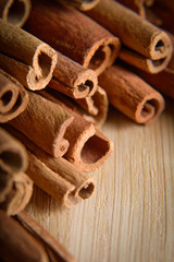  shelves of cinnamon on a wooden background