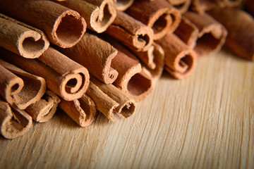  shelves of cinnamon on a wooden background