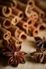  shelves of cinnamon and anise stars in dark backgrounds on a wooden background