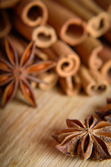  shelves of cinnamon and anise stars in dark backgrounds on a wooden background