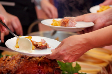 Roasted meat and baked potatoes at the party