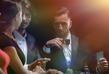 Upper class friends gambling in a casino