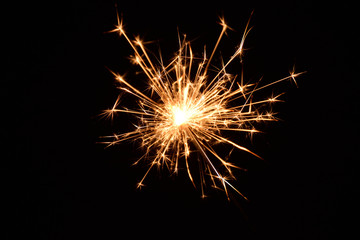 Blank background with bengal fire .Sparkler . New year party sparkler on black background A man holds a burning Bengal flame in his hands