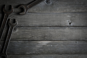 Dirty set of hand tools on a wooden background. Old rusty tools Sales tools for assembly workers.  Old shop Old working. Vintage working tools (drill, saw, ruler and others) on wooden background