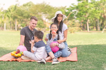 Fototapeta premium Young family with children having fun in nature