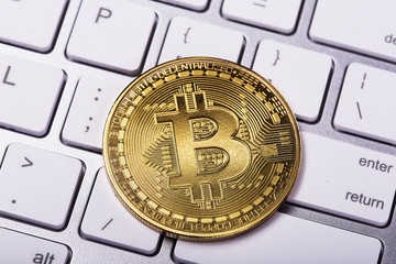 Golden bitcoin coin on keyboard. New virtual money. Cryptocurrency. Business and Trading concept